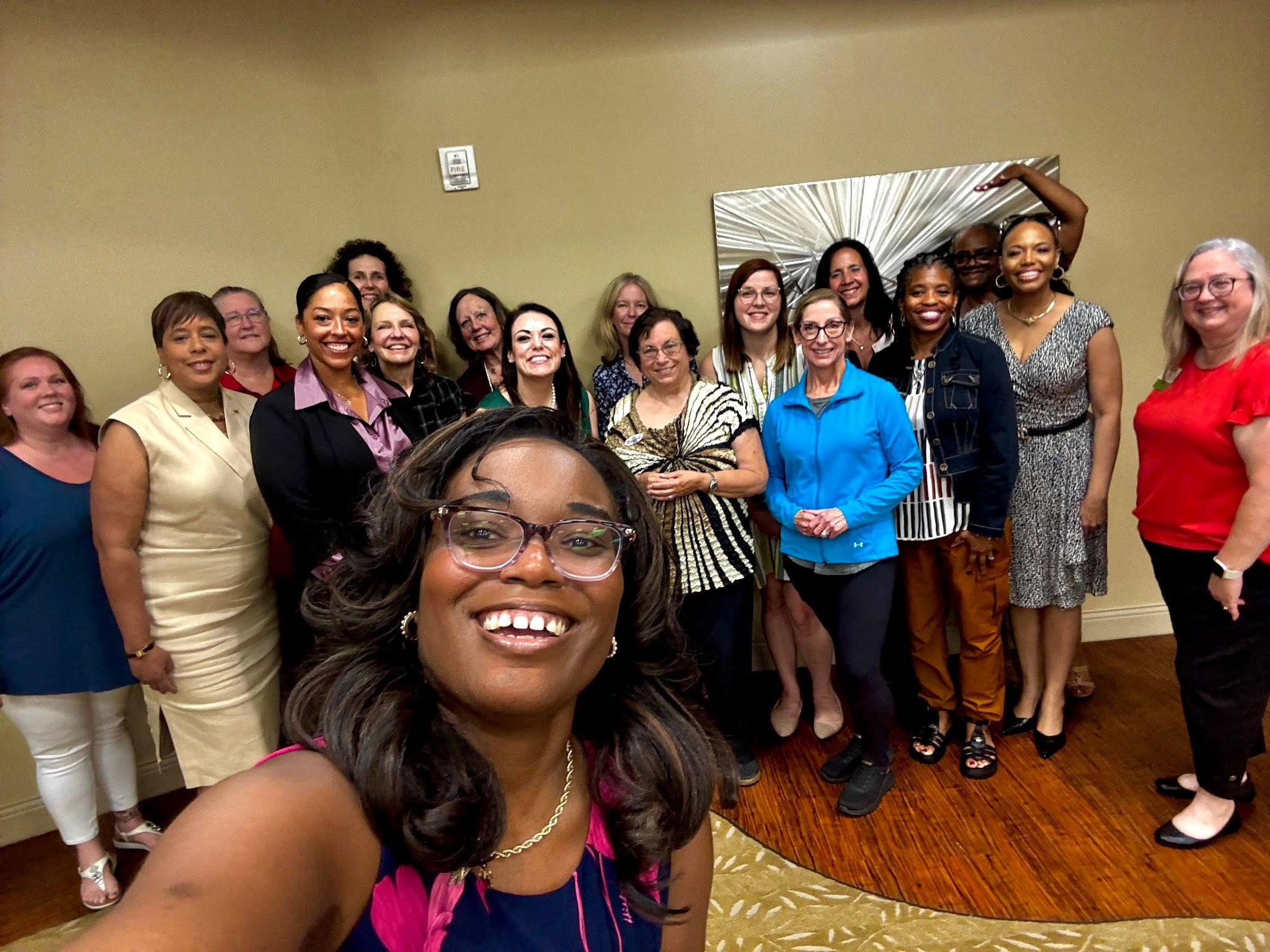 Whitney with a diverse group of women after a learning experience
